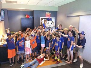 Shot of the library group hanging with  Mr. Met in a  Citi Field suite