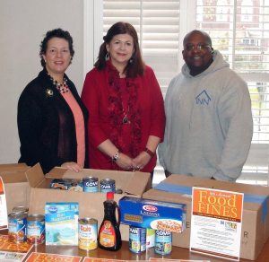 From left: Ellen Broder, Joan Casson Sauer of the Bryant Library  and Kevin Fournilier, donations  coordinator for The INN