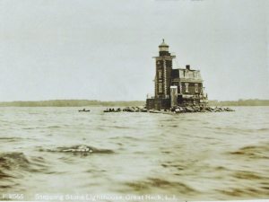 This real photo postcard of the lighthouse shows people in rowboats around 1910.