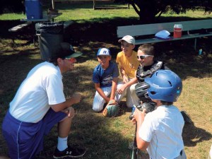 Campers hanging out in the dugout at the New York Baseball Academy