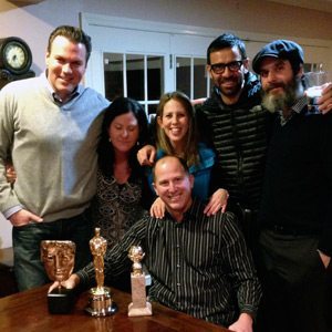 Standing left to right: James O’Connell, Gaby Karikas, Shari Young, Reza Jarrahy and Anthony Katagas. Sitting in front: Ted Karikas with the BAFTA Award, Academy Award and Golden Globe (Photo courtesy of Anthony Katagas)