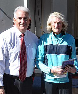 Town Councilman Chris Coschignano congratulates Nina Jennings of Mill Neck on being the first woman finisher in the 75-79 age group. oysterbay 2012 10 run 8 award