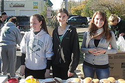 Some teens and a lovely lady help serve hamburgers. oysterbay 2012 11 lvbbq 5