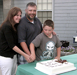 Kerrie, Thomas and Cameron Ross cut the delicious cake filled with raspberry and chocolate mousse. oysterbay 2013 09 6 rossb
