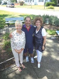 Library director Gretchen Browne, chamber president Elan Wurtzel, chamber board member and past president Francesca Carlow stand in front of the Alma Craib Memorial Garden located next to the library, where the 9/11 sculpture will be displayed. (Photo by Chris Boyle)