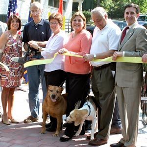 Local dignitaries -- and a couple of invited guests -- unveil the new doggy space.