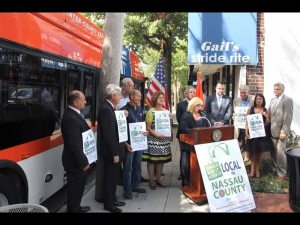 Nassau County Executive Edward Mangano and local official hold sign for “Shop Local” outside of Gail’s Stride Rite on Main Street. (Photo by Chuck Idol)