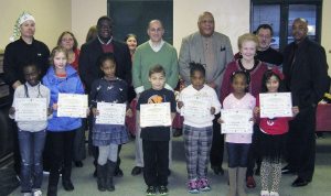 Local community leaders with the winners of the poster contest 