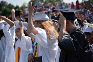 Graduates turn their tassels.