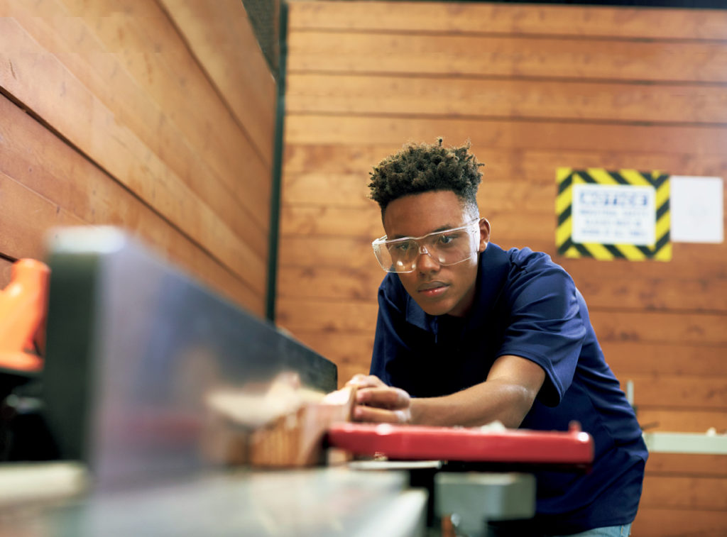 Carpenter Using Plane In Woodworking Woodshop