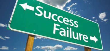 Success and Failure Road Sign with dramatic clouds and sky.