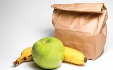 Bag lunch with a banana and an apple.