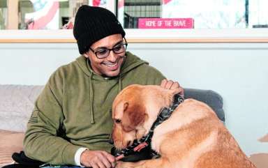 Gustav, a dog rescued overseas by a deployed service member, with Mike Kilano, a Paws of War volunteer.