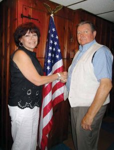 Immediate Past President of the Floral Park Lions Club Helen Farley is pictured congratulating Lion Jim Whalen, who is the newly installed president. 