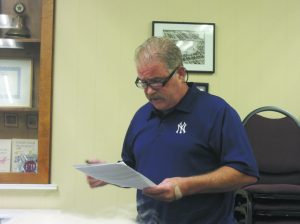 Attendee Tom Skinner reading from past meetings minutes about Mayor Tangredi’s take on the job hire. (Photos by Dave Gil de Rubio)