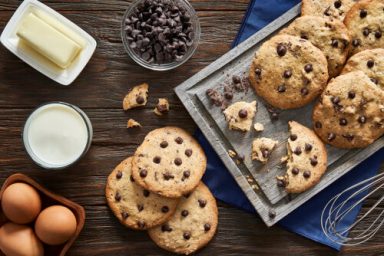 Top view of homemade chocolate chips cookies on a rustic wooden table