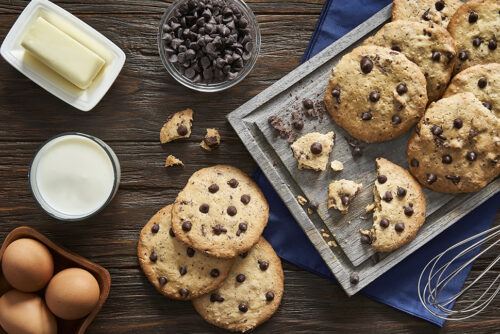 Top view of homemade chocolate chips cookies on a rustic wooden table
