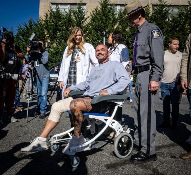 Wounded New York State Trooper Thomas Mascia leaves in wheelchair from hospital in East Meadow, New York.