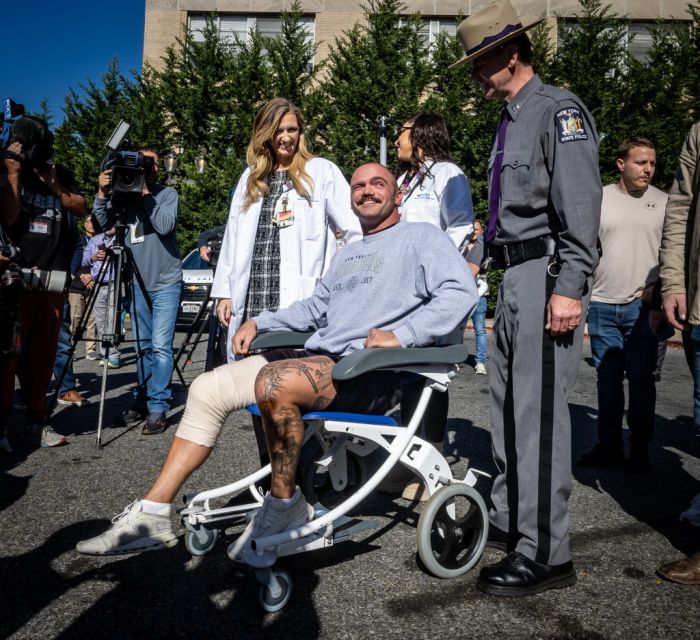 Wounded New York State Trooper Thomas Mascia leaves in wheelchair from hospital in East Meadow, New York.