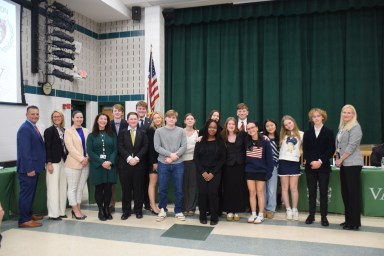 Locust Valley district officials stand with members of the Model UN club at the Wednesday, March 26 board of education meeting