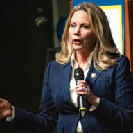 Gillen speaking into a microphone.