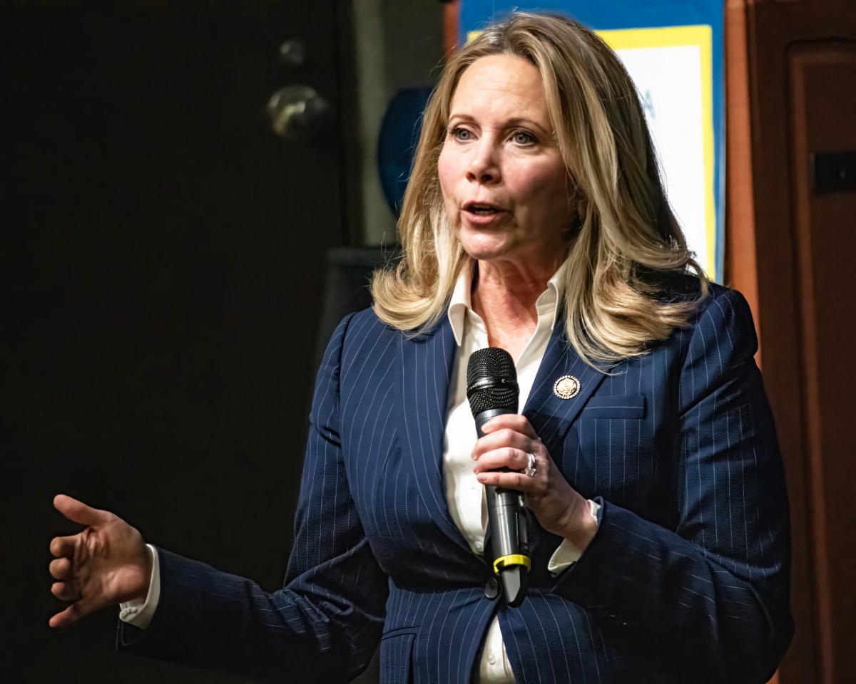 Gillen speaking into a microphone.