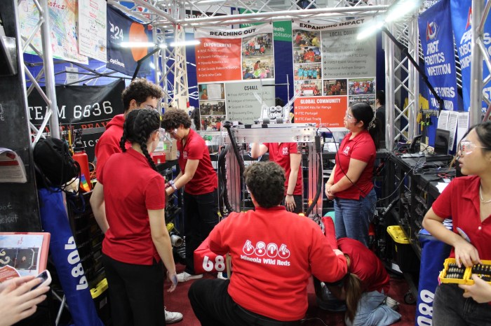 Mineola engineering students work on a robot.