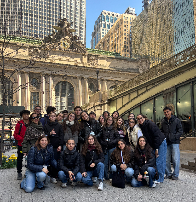 Mineola students and Portuguese students sit together outside Grand Central