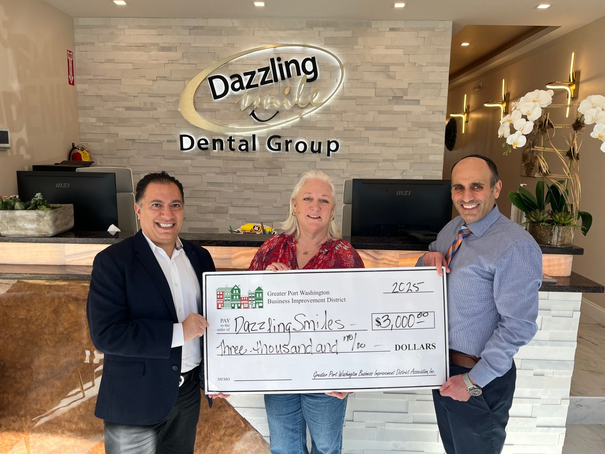 Hooman Neman (L.) and Armin Lalehzari (R.) of the Dazzling Smile Dental Group received a $3,000 grant from the Port Washington Business Improvement District, represented by Executive Director Holly Byrne (C.).