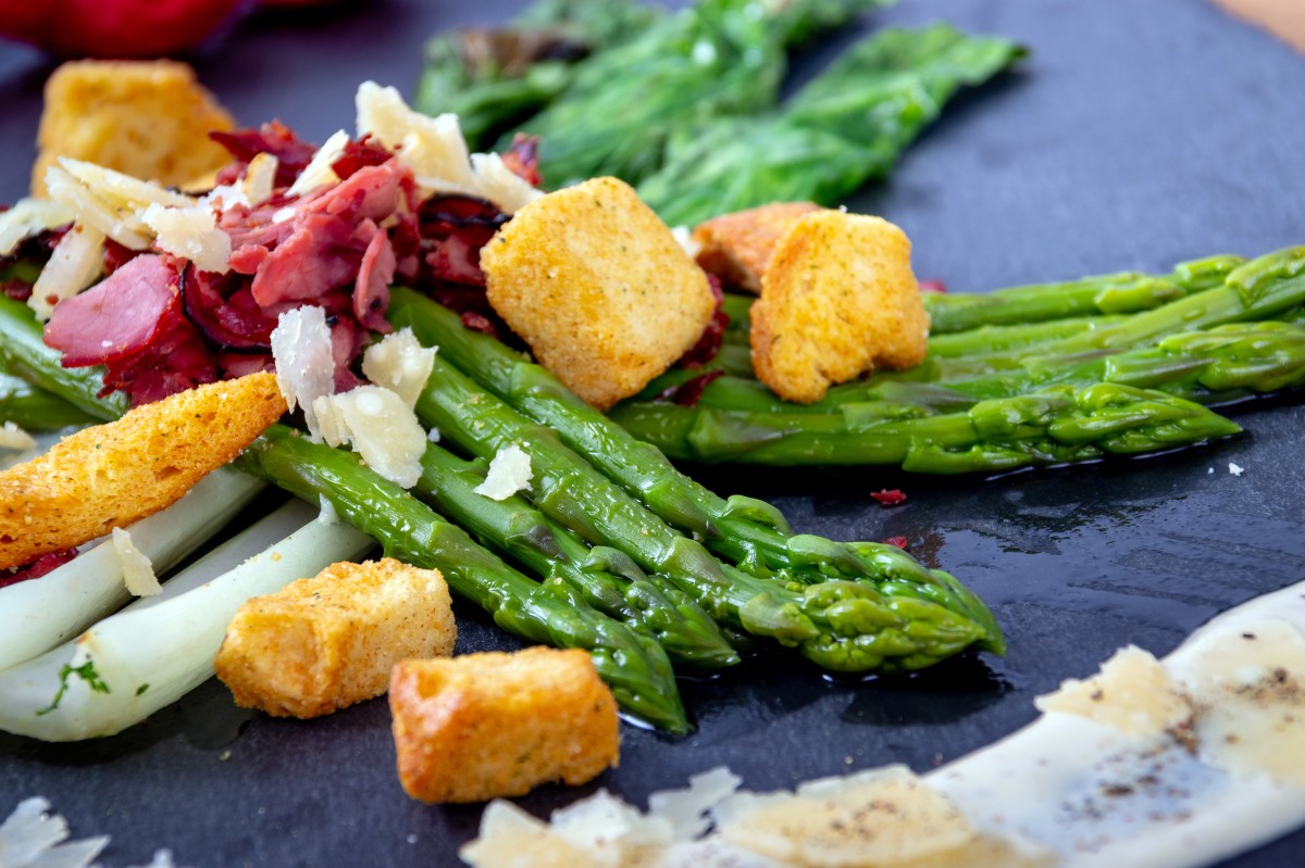 caesar asparagus with sliced Parmesan cheese smoked meat and crouton gourmet cuisine dish