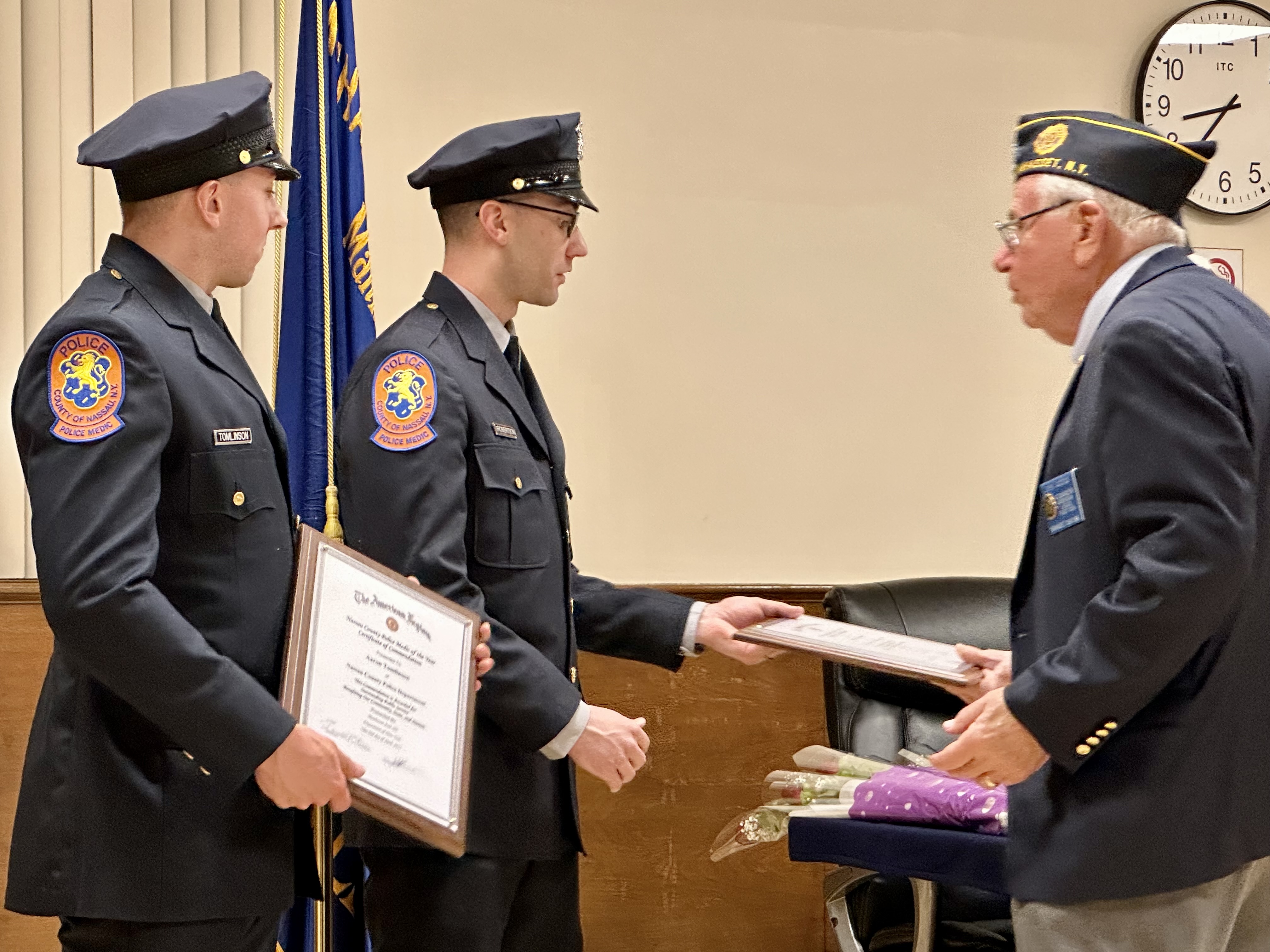Manhasset American legion Commander John Iacono (right) handing awards to Nassau County medics Aaron Tomlinson (left) and Richard Robinson (center)