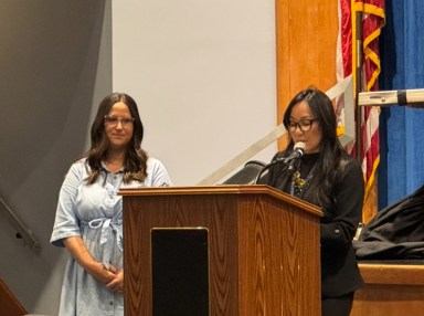 Kim Libertini, the Jericho curriculum associate for science and technology education, congratulates teachers receiving tenure at the Thursday, April 24 board of education meeting.
