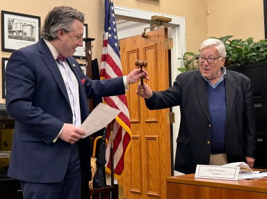 (L-R) Roslyn Estates Mayor Adam Koblenz was sworn in on April 21 by his father, East Hills Mayor Michael Koblenz, who presented his son with a 'lucky gavel.'