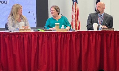 Mineola board members sitting and talking.