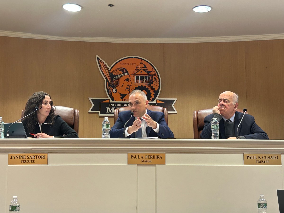 Mineola's Board of Trustees sits and speaks at their Wednesday meeting.