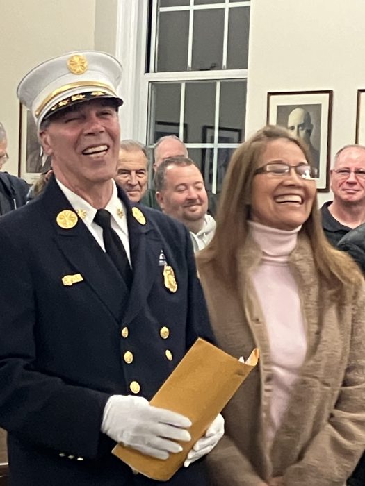 Two people standing in Floral Park Village Hall.