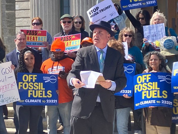 People speak and cheer at a rally in support of the HEAT Act.