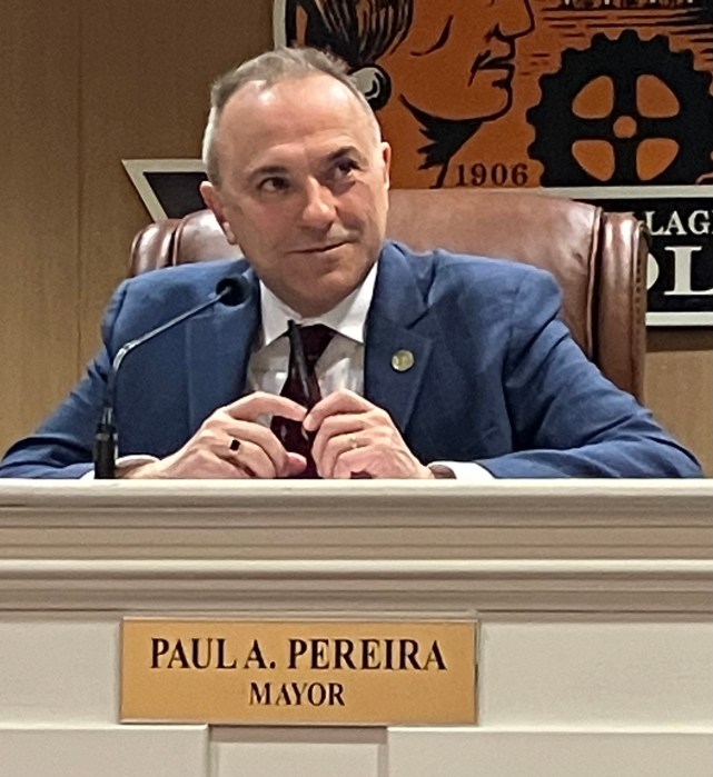 Mineola mayor sits and smiles.