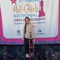Leah Yang, an eighth grader from Jericho Middle School, stands with her second place trophy at the All-Girls National Chess Championships in Chicago