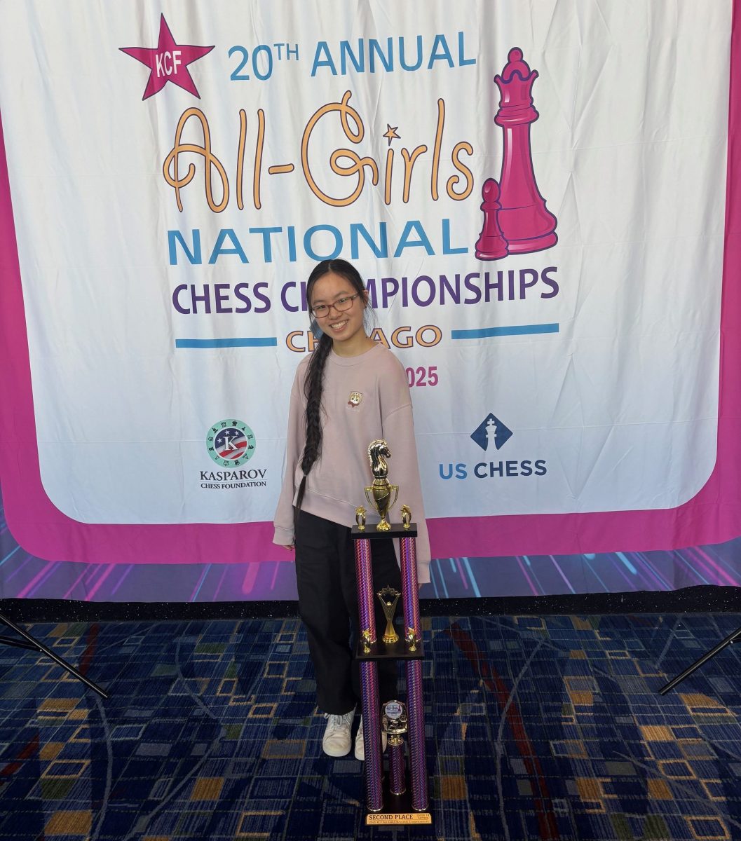 Leah Yang, an eighth grader from Jericho Middle School, stands with her second place trophy at the All-Girls National Chess Championships in Chicago