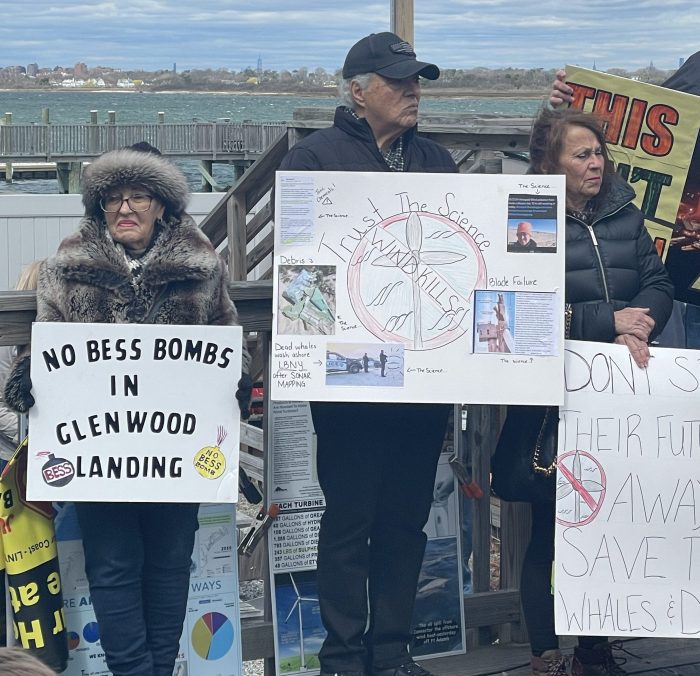 Community members holding signs against large energy projects on Long Island