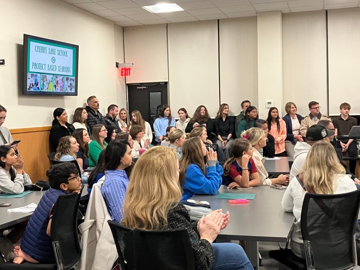 Carle Place families and teachers sit at a recent board meeting to celebrate student athletes.