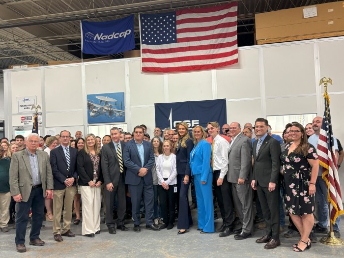 Kelly-Loeffler-center-in-dark-blue-stands-with-Anne-Shybunko-Moore-