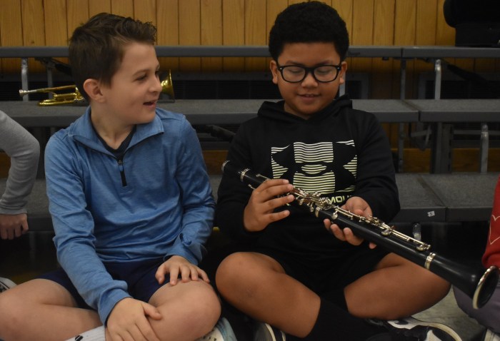 Timmy Garcia (L) and Jayce Rivera looked at a clarinet