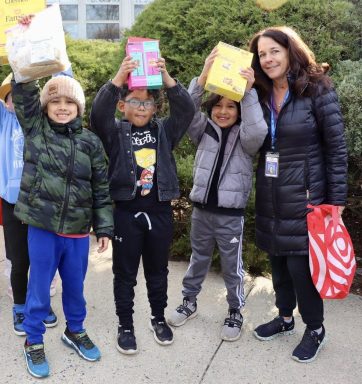 Manorhaven first graders collect non-perishable food items for the Our Lady of Fatima food pantry.