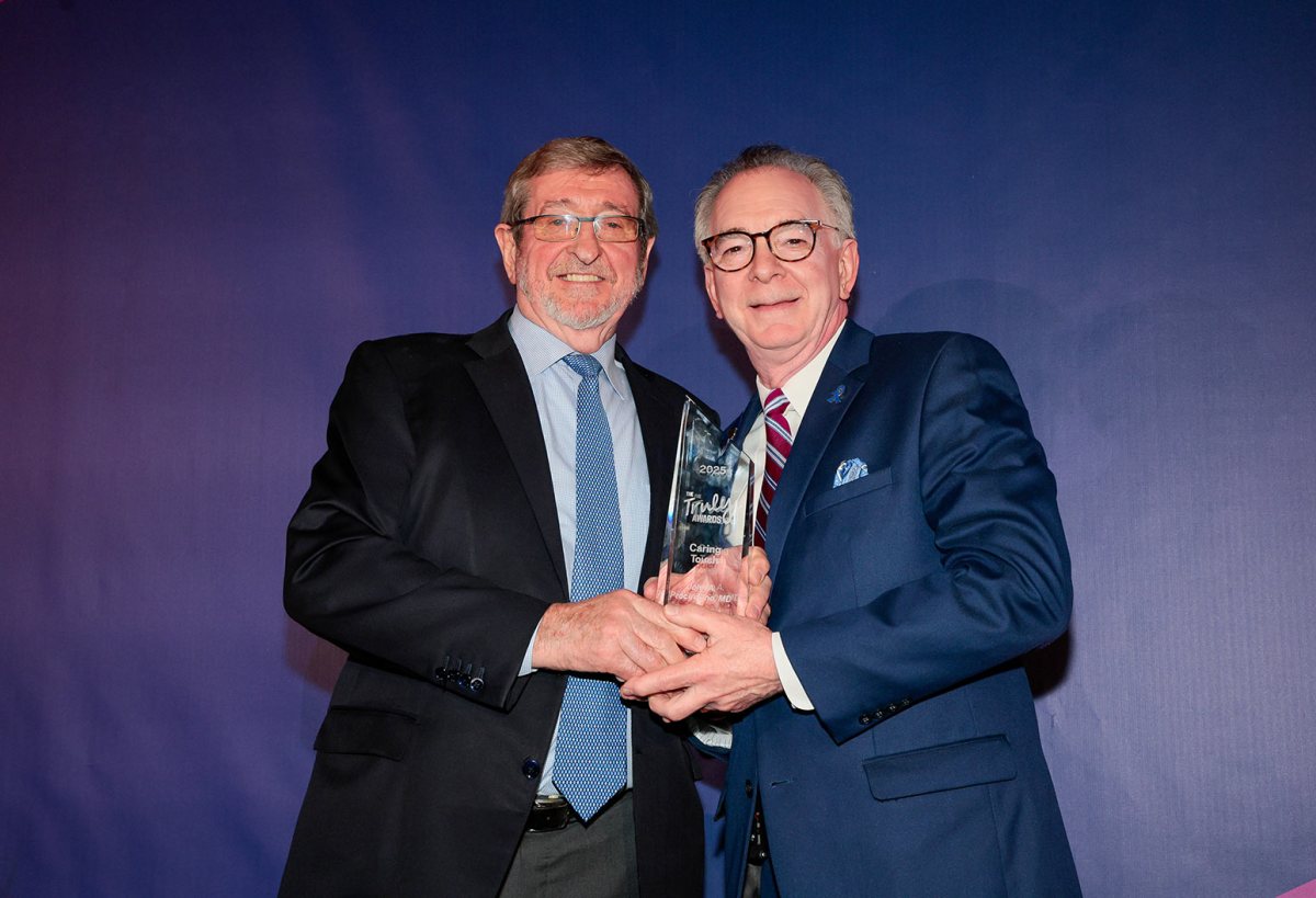 Dr. John Procaccino (R.) receiving the "Truly Caring Touch" award from Northwell Health President and CEO Michael Dowling (L.).