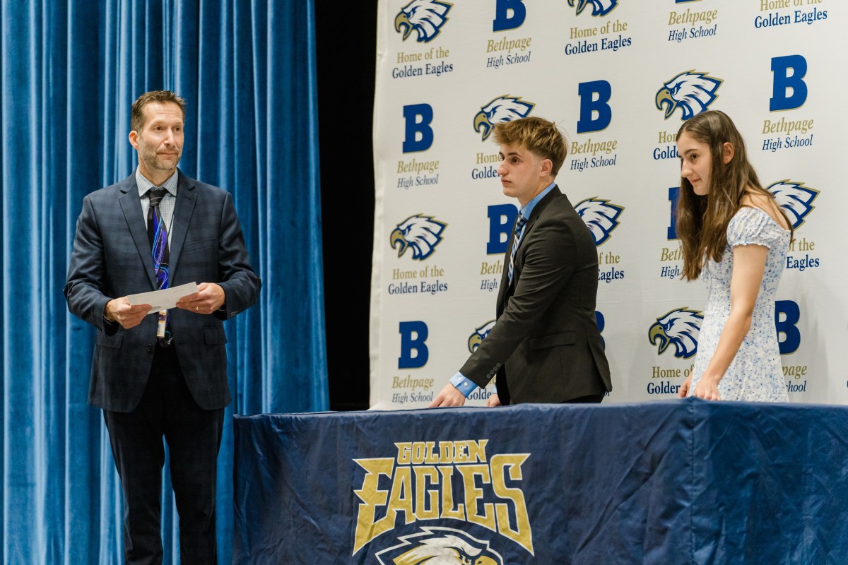 John Titolo, Thomas Lagan and Kaitlyn Ocuto (L.to R.) distribute certificates to Bethpage High School's Math Honor Society