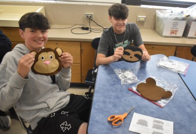 Berner Middle School students Jack Cohen (L.) and Andrew Bacheller (R.) worked on their sewing projects, a monkey and a sloth, respectively.