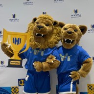 Hofstra University's mascots, Kate and Willie Pride, pose with the school's new logo ahead of it's centennial celebration.