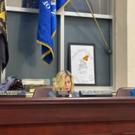 Glen Cove Mayor Pam Panzenbeck (C.) discusses battery energy storage systems and local noise laws with city council members